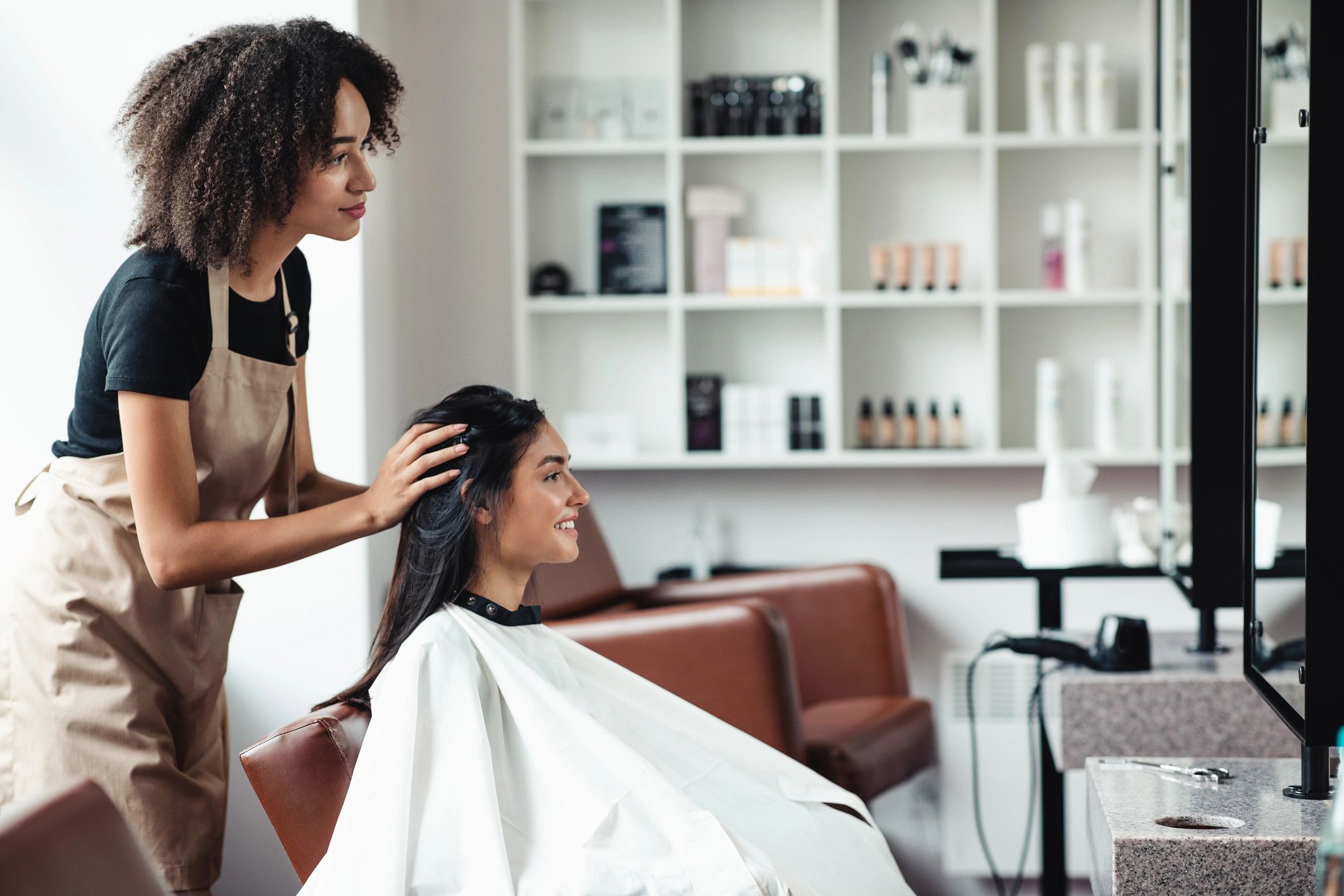 A woman getting her hair styled in a modern salon.